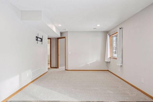 spare room with light carpet, baseboards, visible vents, and recessed lighting