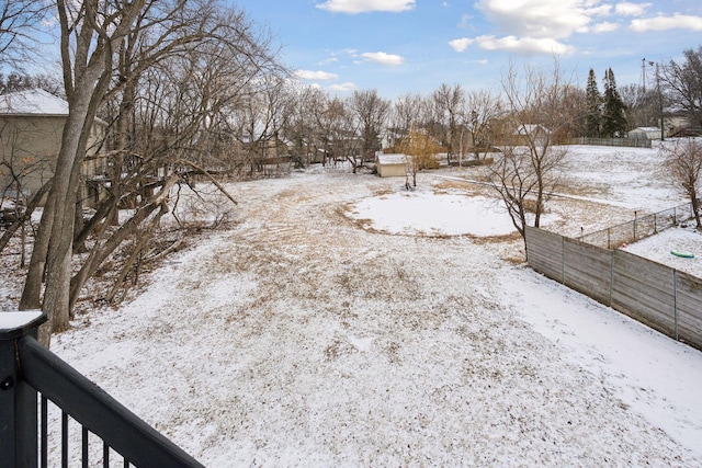 snowy yard with fence