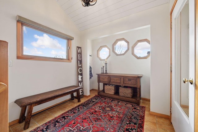 foyer with lofted ceiling and baseboards