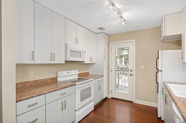 3054 Lake Shore Dr Unit B, Minneapolis, MN 55416 - kitchen with dark wood-style flooring, white appliances, visible vents, white cabinetry, and baseboards