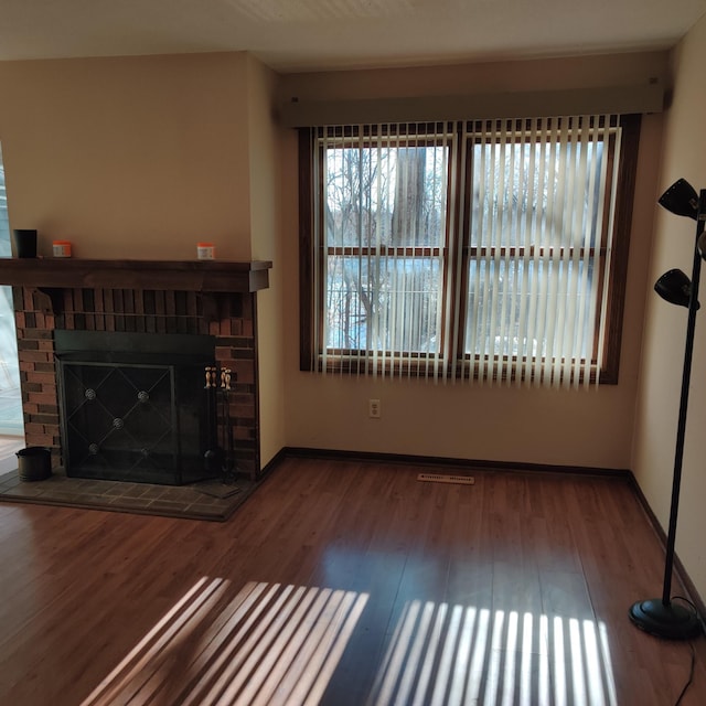 unfurnished living room featuring hardwood / wood-style floors and a fireplace