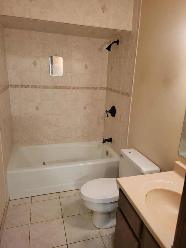 full bathroom with tile patterned flooring, vanity, tiled shower / bath combo, and toilet