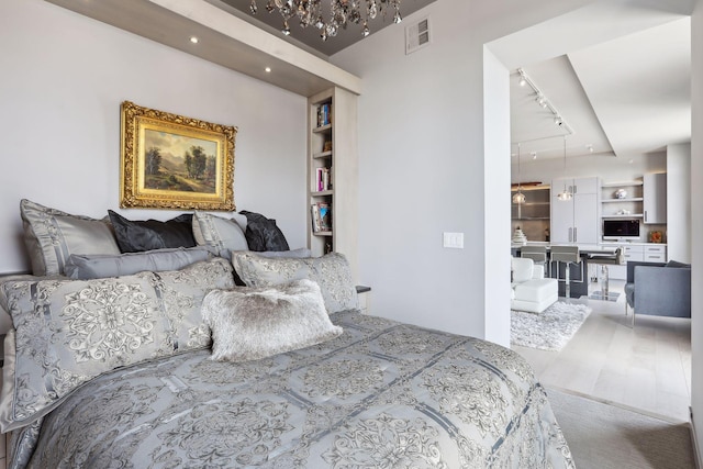 bedroom featuring rail lighting