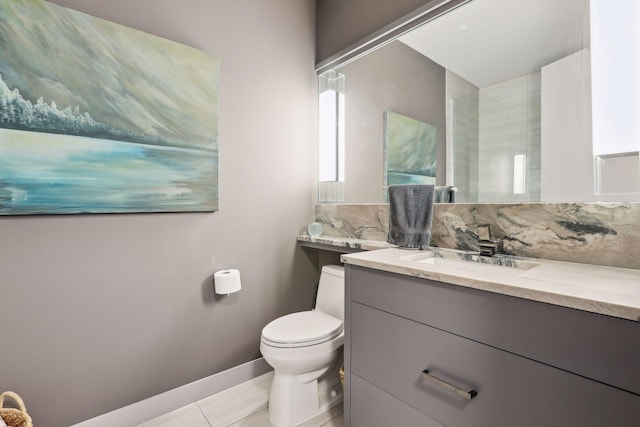 bathroom featuring vanity, toilet, and tile patterned flooring