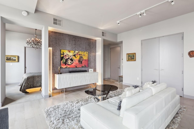 201 11th St Unit 1140, Minneapolis, MN 55403 - living room featuring a chandelier, rail lighting, visible vents, and light wood-type flooring