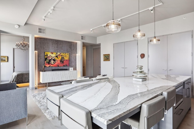 201 11th St Unit 1140, Minneapolis, MN 55403 - dining room with track lighting, a chandelier, light wood-style flooring, and visible vents