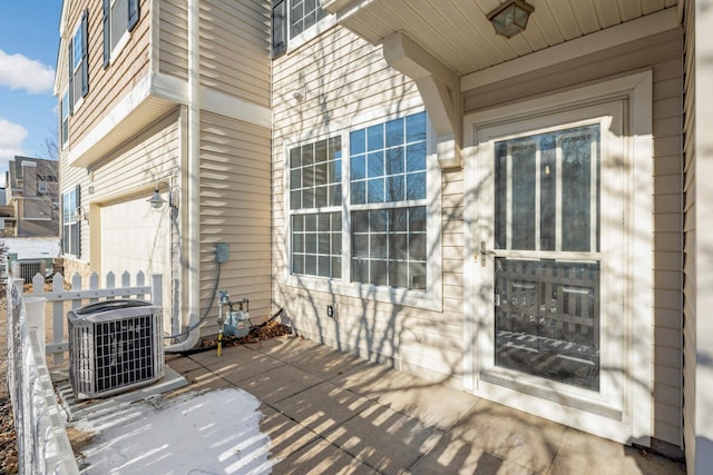 exterior space featuring a garage and central air condition unit