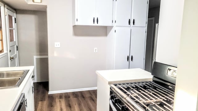 kitchen with white cabinetry, dishwasher, sink, dark wood-type flooring, and stainless steel range with gas stovetop