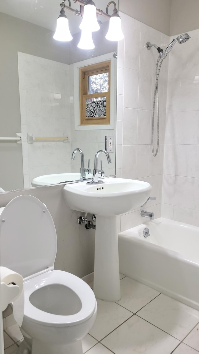 bathroom with tiled shower / bath, toilet, and tile patterned flooring