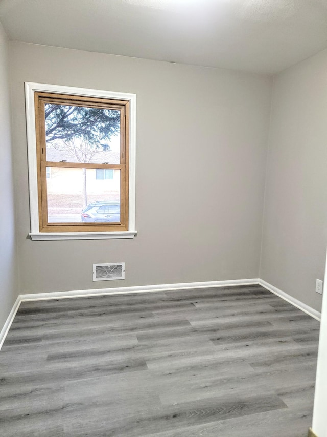 unfurnished room with hardwood / wood-style floors