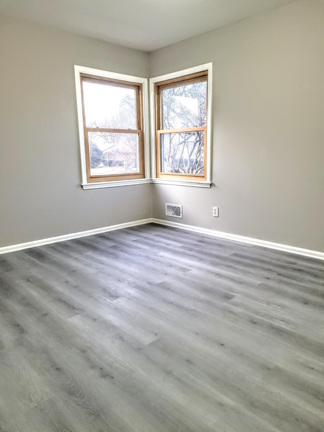 spare room with hardwood / wood-style floors