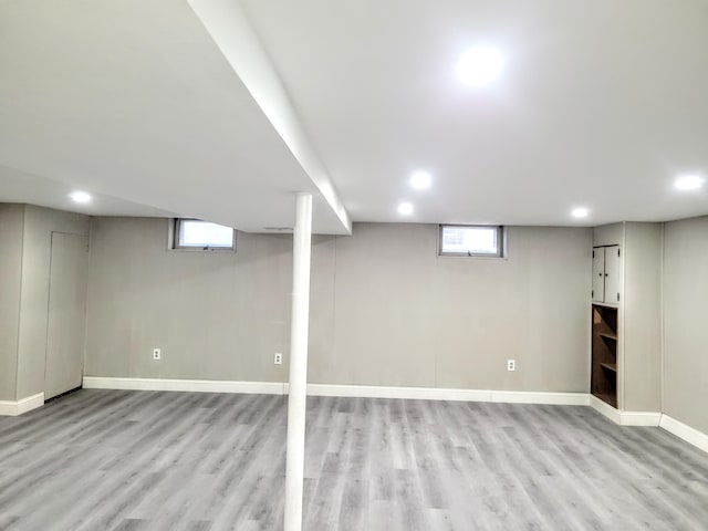 basement with light hardwood / wood-style flooring