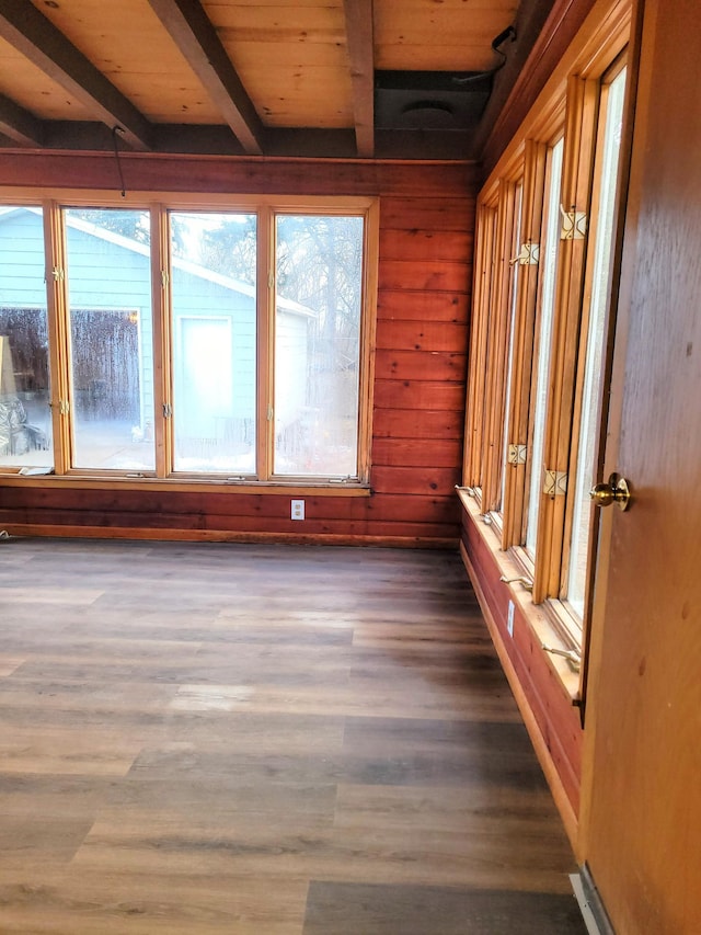 unfurnished sunroom featuring wood ceiling and beam ceiling