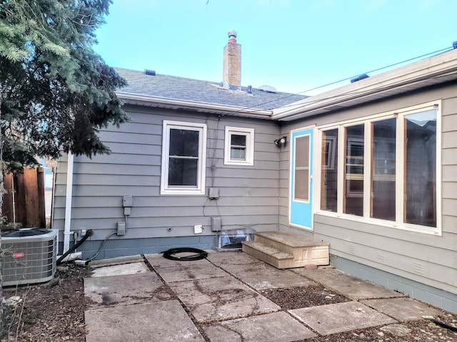 back of property featuring cooling unit and a patio