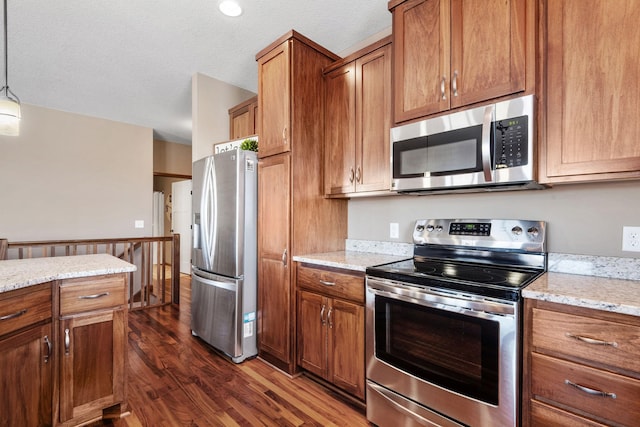 kitchen with brown cabinets and appliances with stainless steel finishes