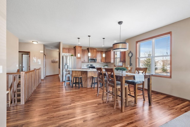 dining area featuring baseboards and wood finished floors