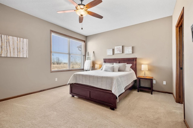 bedroom with baseboards, a textured ceiling, ceiling fan, and carpet flooring