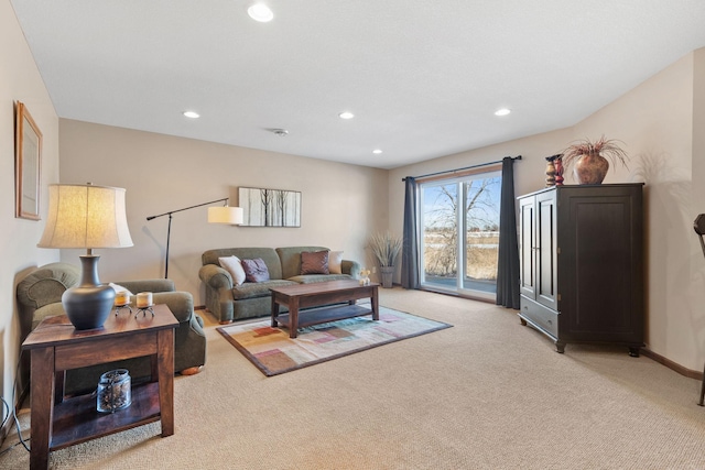 living area featuring recessed lighting, baseboards, and light carpet