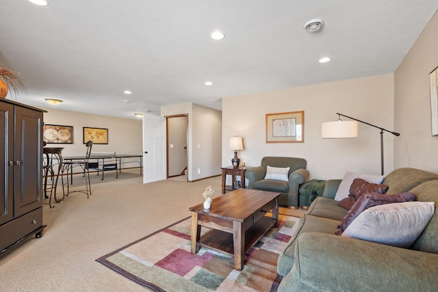 living area featuring recessed lighting, baseboards, and light carpet