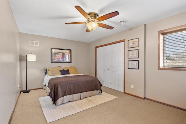 carpeted bedroom featuring visible vents, baseboards, and a ceiling fan