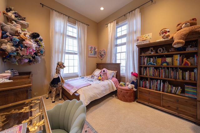 bedroom featuring multiple windows and carpet flooring