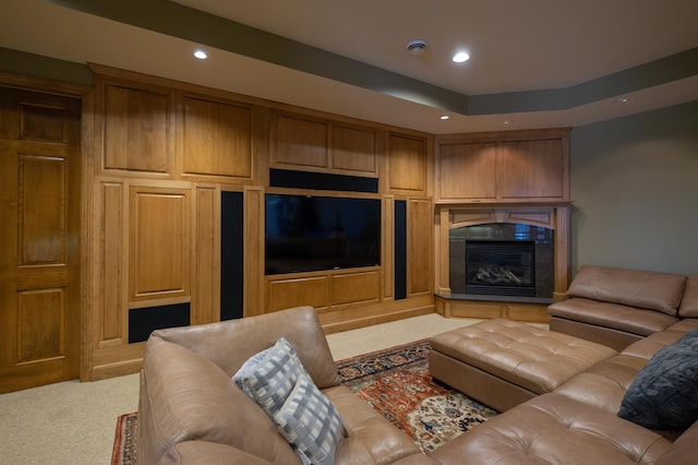 carpeted living room featuring a tray ceiling