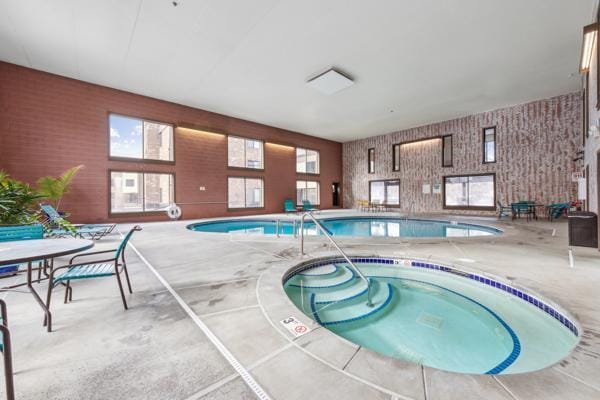 view of swimming pool with an indoor hot tub