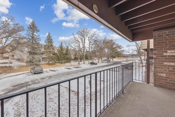 view of snow covered back of property