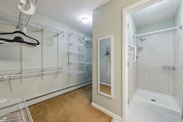 walk in closet with a baseboard heating unit