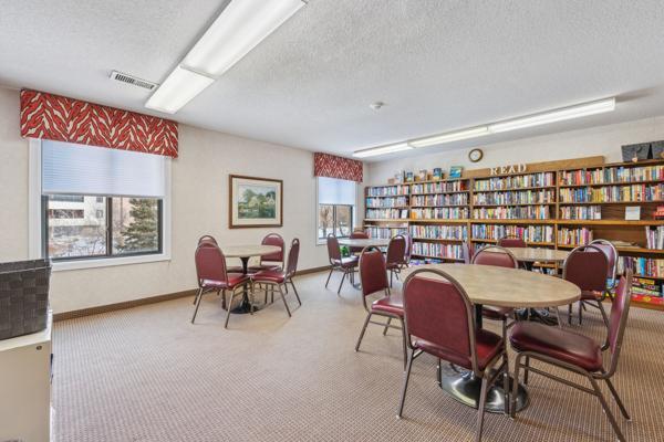 dining room featuring light colored carpet and a textured ceiling