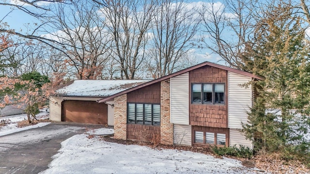 view of snow covered exterior with a garage