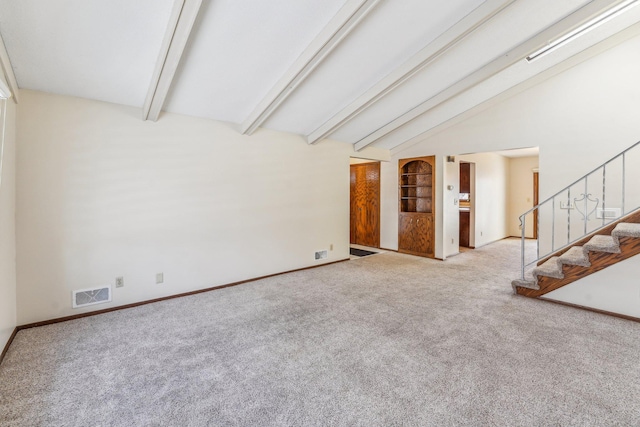 unfurnished living room with light carpet and vaulted ceiling with beams