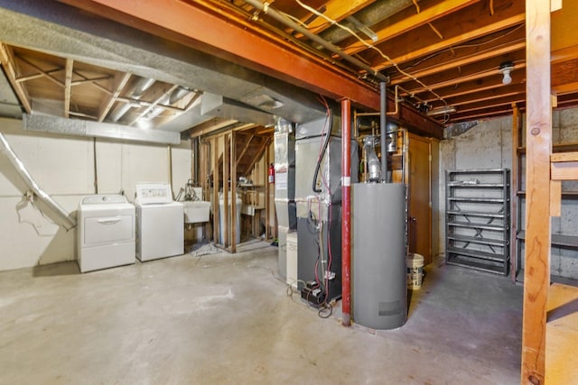 basement with gas water heater, sink, heating unit, and washer and clothes dryer