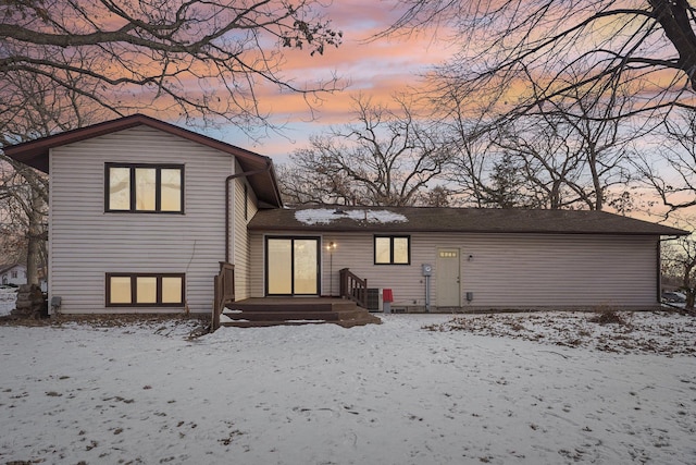 view of snow covered rear of property