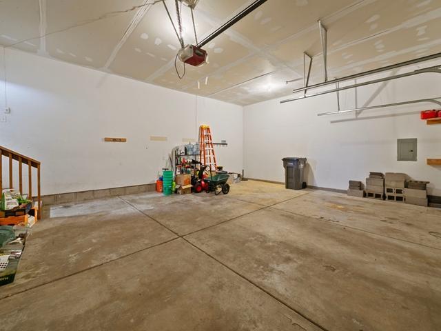 garage featuring a garage door opener and electric panel