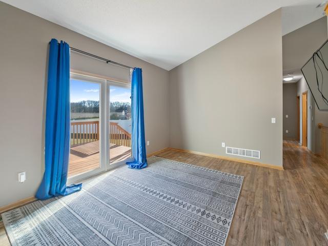 spare room with visible vents, baseboards, and wood finished floors