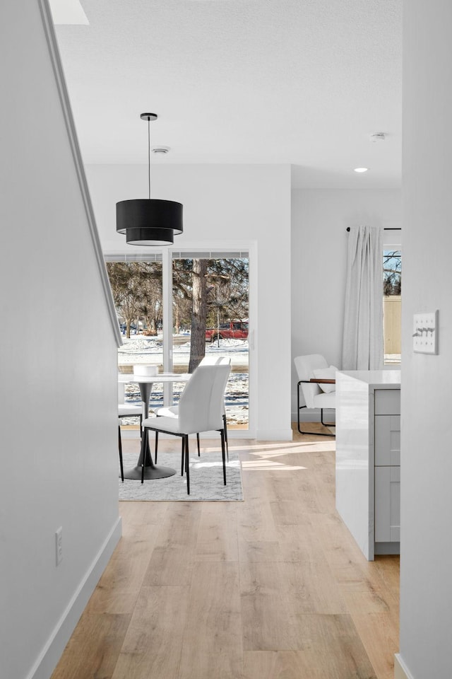 unfurnished dining area with a healthy amount of sunlight and light wood-type flooring