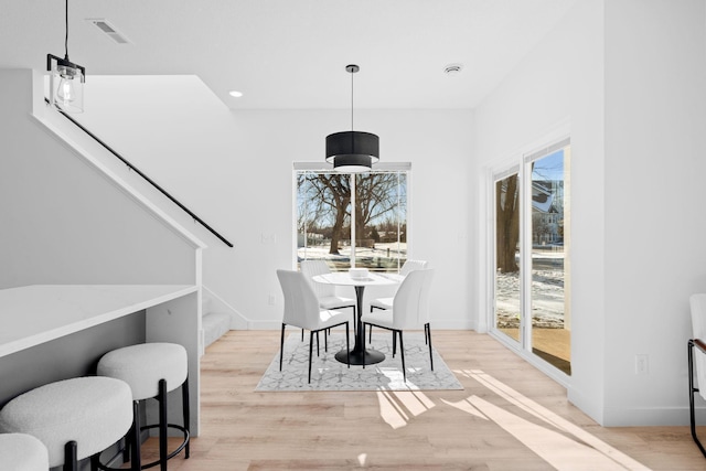 dining space featuring light wood-type flooring