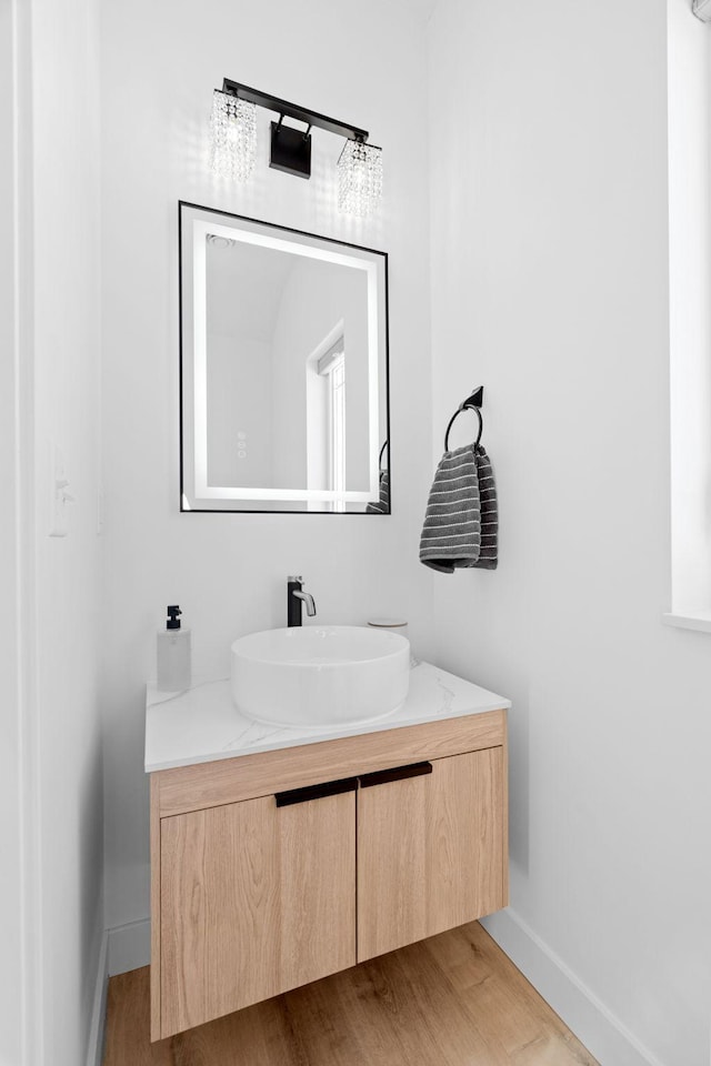 bathroom featuring hardwood / wood-style flooring and vanity