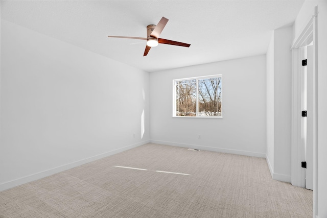 empty room with light colored carpet and ceiling fan