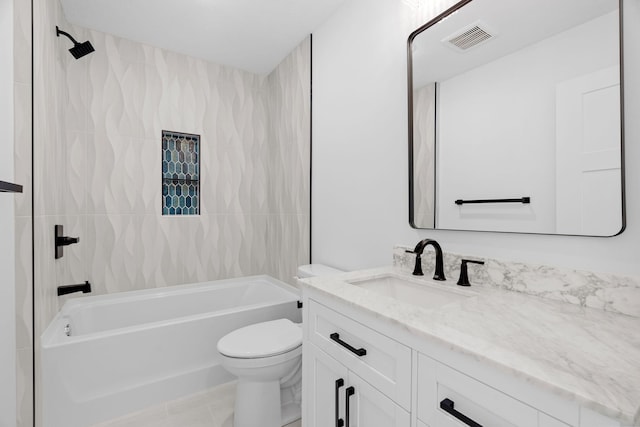 full bathroom with tiled shower / bath, vanity, and toilet