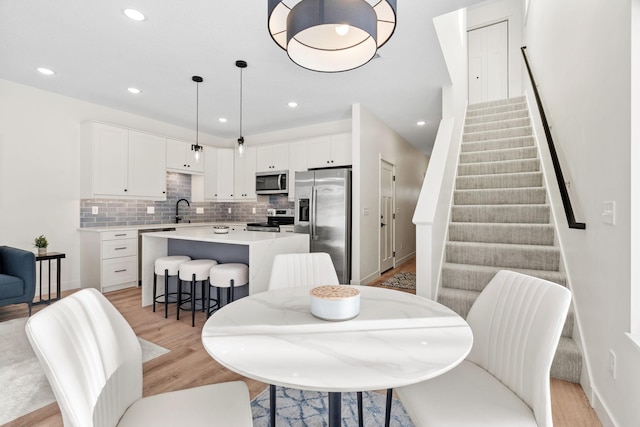 dining room with sink and light hardwood / wood-style floors