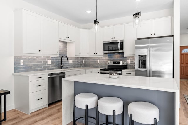 kitchen with sink, stainless steel appliances, and white cabinets