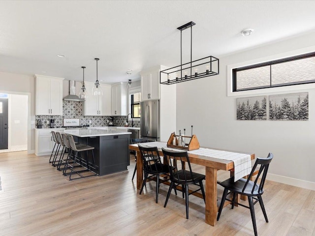 dining space featuring sink and light hardwood / wood-style floors