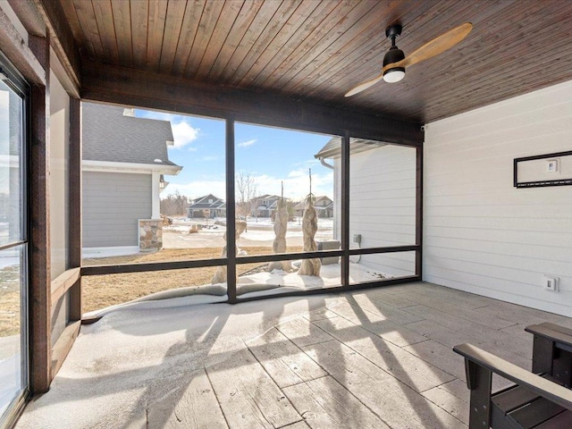 unfurnished sunroom with wooden ceiling and ceiling fan