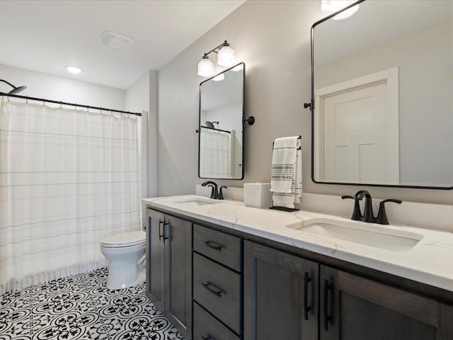 bathroom featuring vanity, tile patterned floors, and toilet