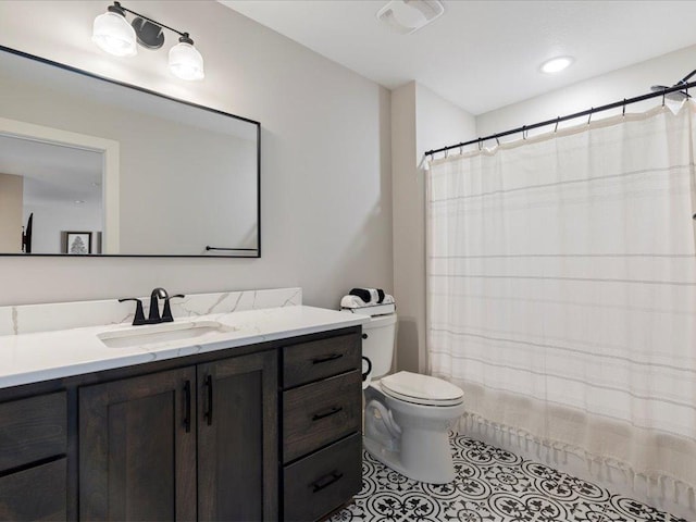 bathroom featuring tile patterned flooring, vanity, and toilet