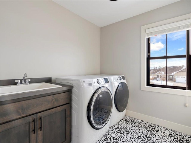 clothes washing area featuring light tile patterned floors, sink, cabinets, and washing machine and clothes dryer