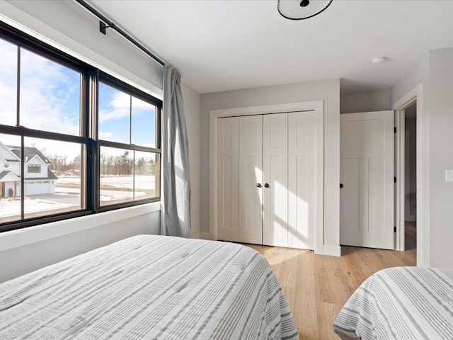 bedroom featuring a closet and light hardwood / wood-style flooring