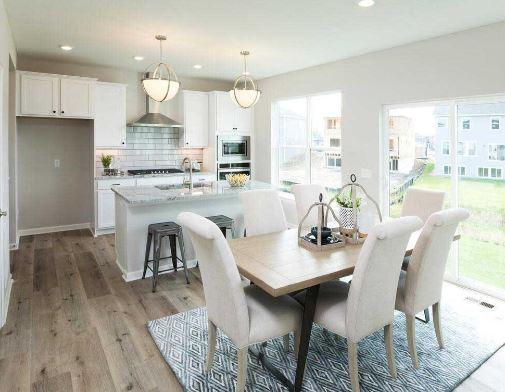 dining area featuring plenty of natural light, sink, and light wood-type flooring